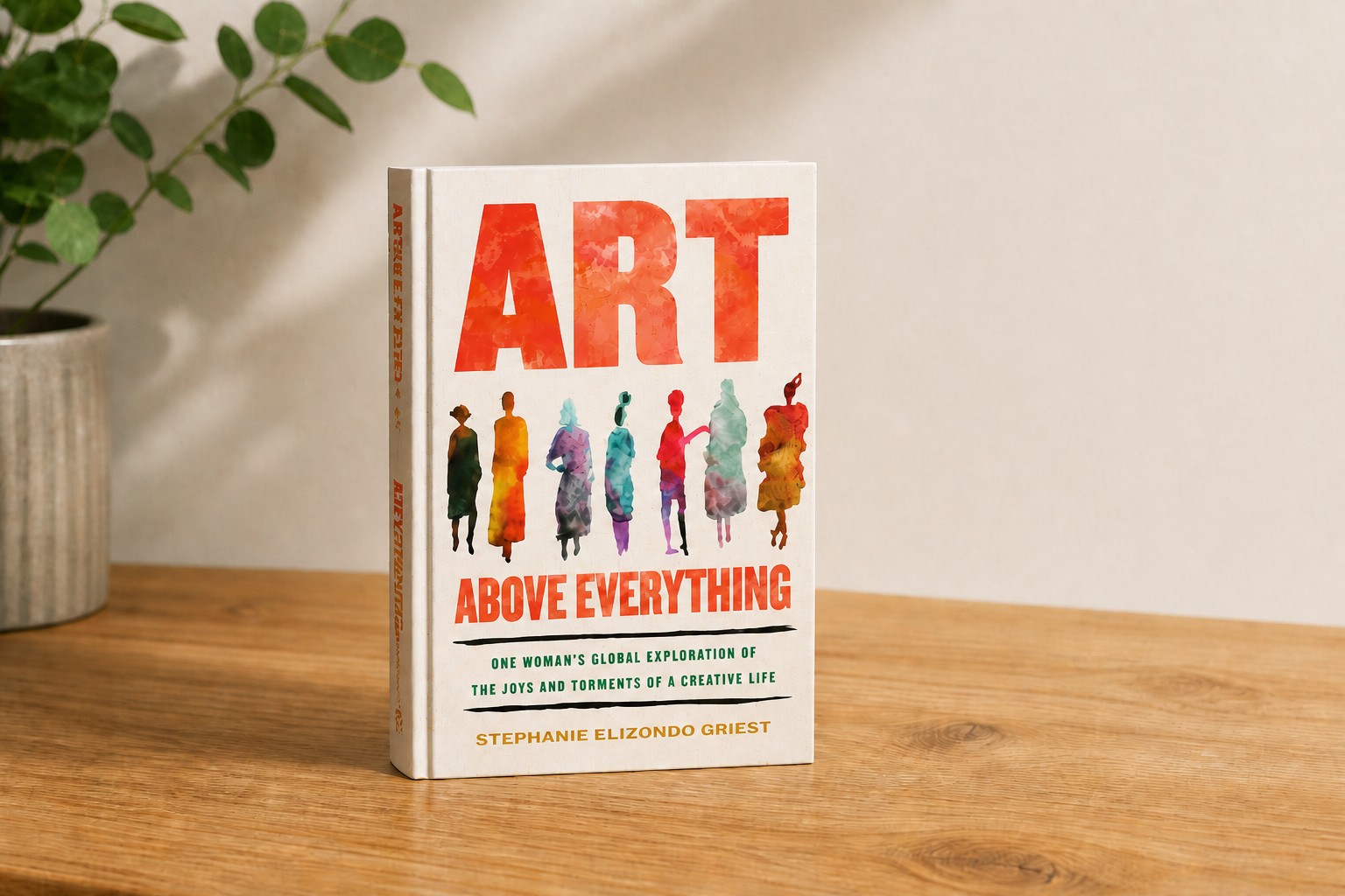 Art Above Everything book displayed on an oak desk